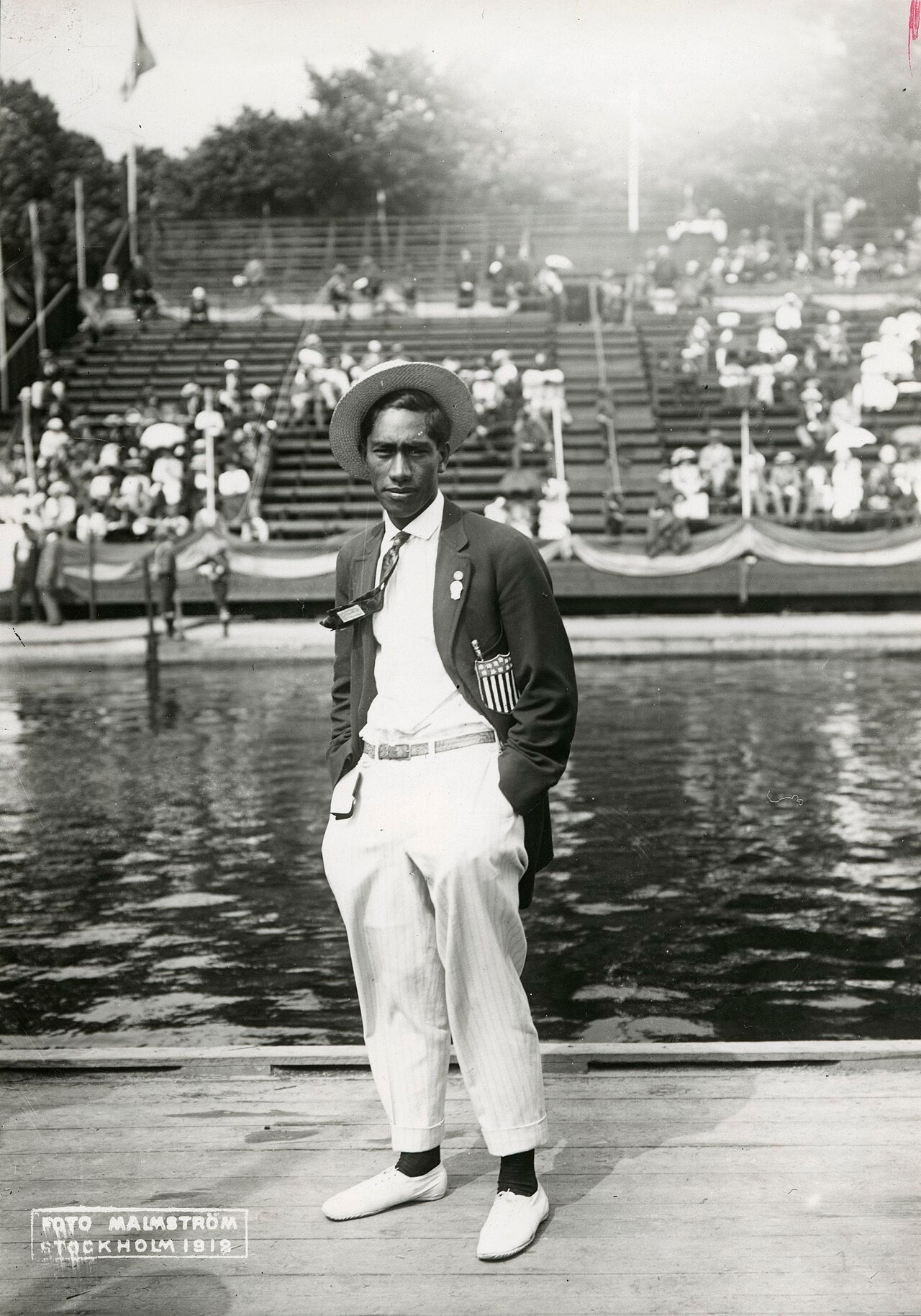 Duke Kahanamoku, the father of modern surfing, c.1912, with his surfboard
