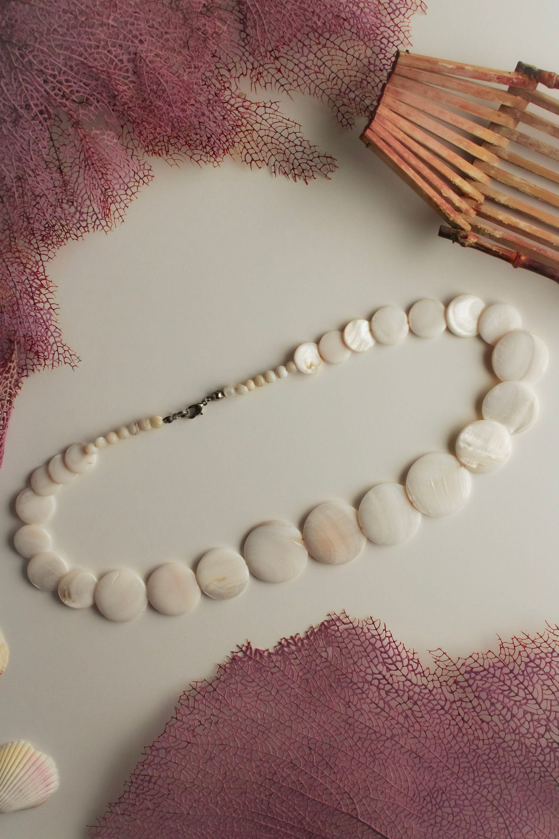 Polished shell-disc necklace, a modern cut-and-polished style often sold as puka style jewelry