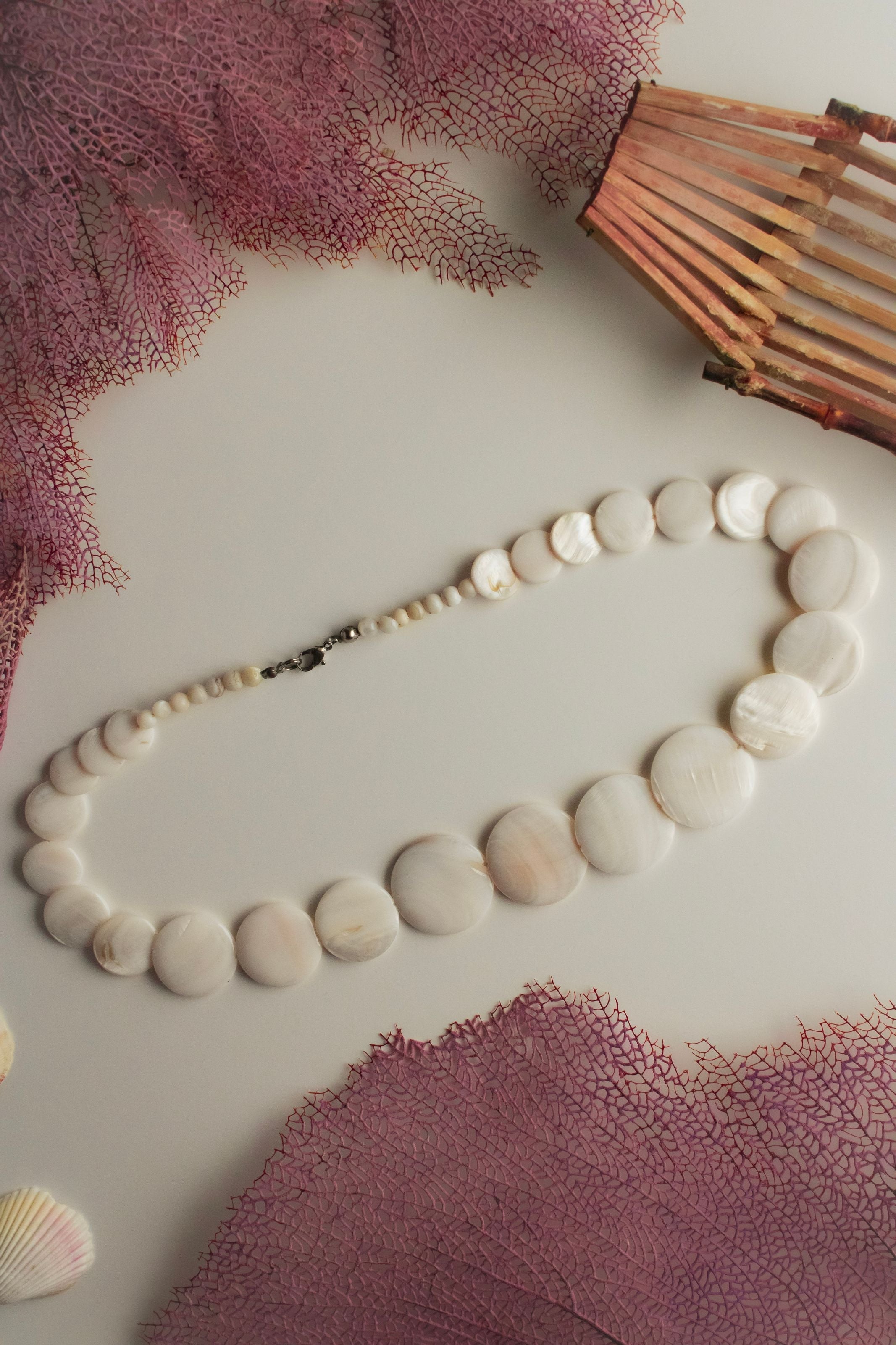 Polished shell-disc necklace, a modern cut-and-polished style often sold as puka style jewelry