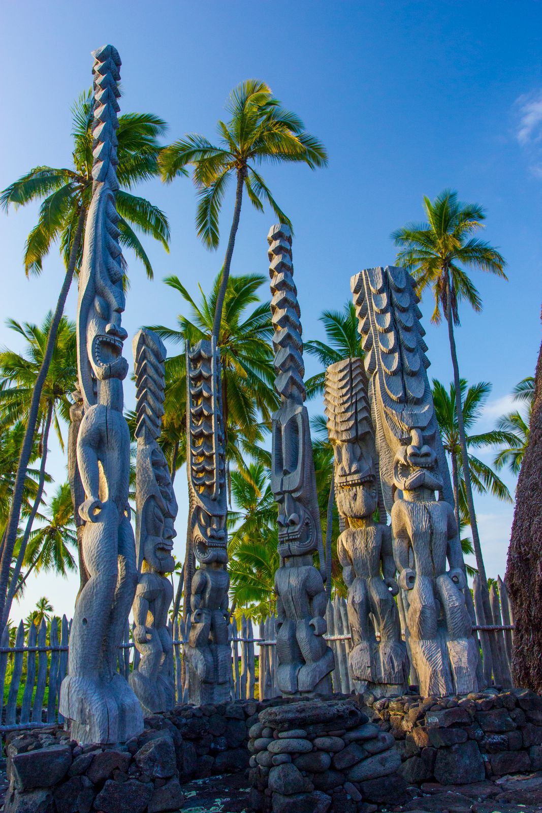 Carved wooden kiʻi guardian images at Puʻuhonua o Hōnaunau, the ancient Hawaiian place of refuge