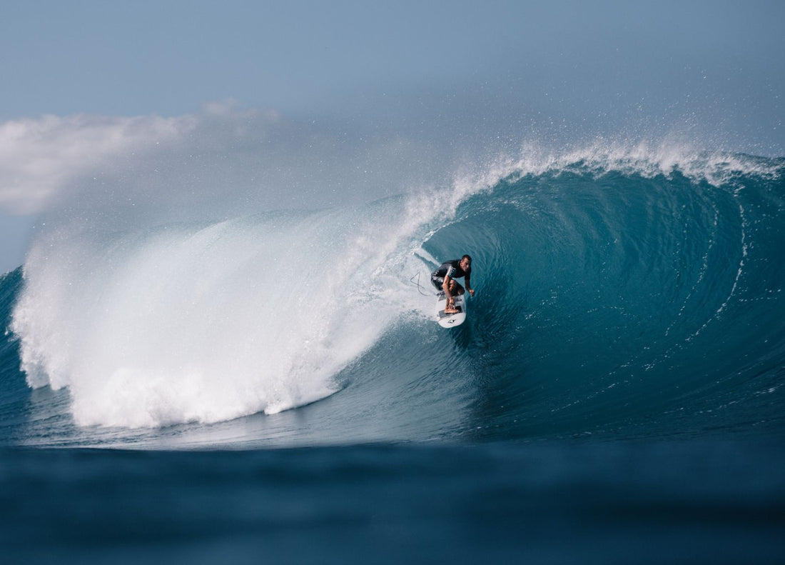 Surfer riding inside a large barreling wave on the North Shore of Oʻahu, Hawaiʻi