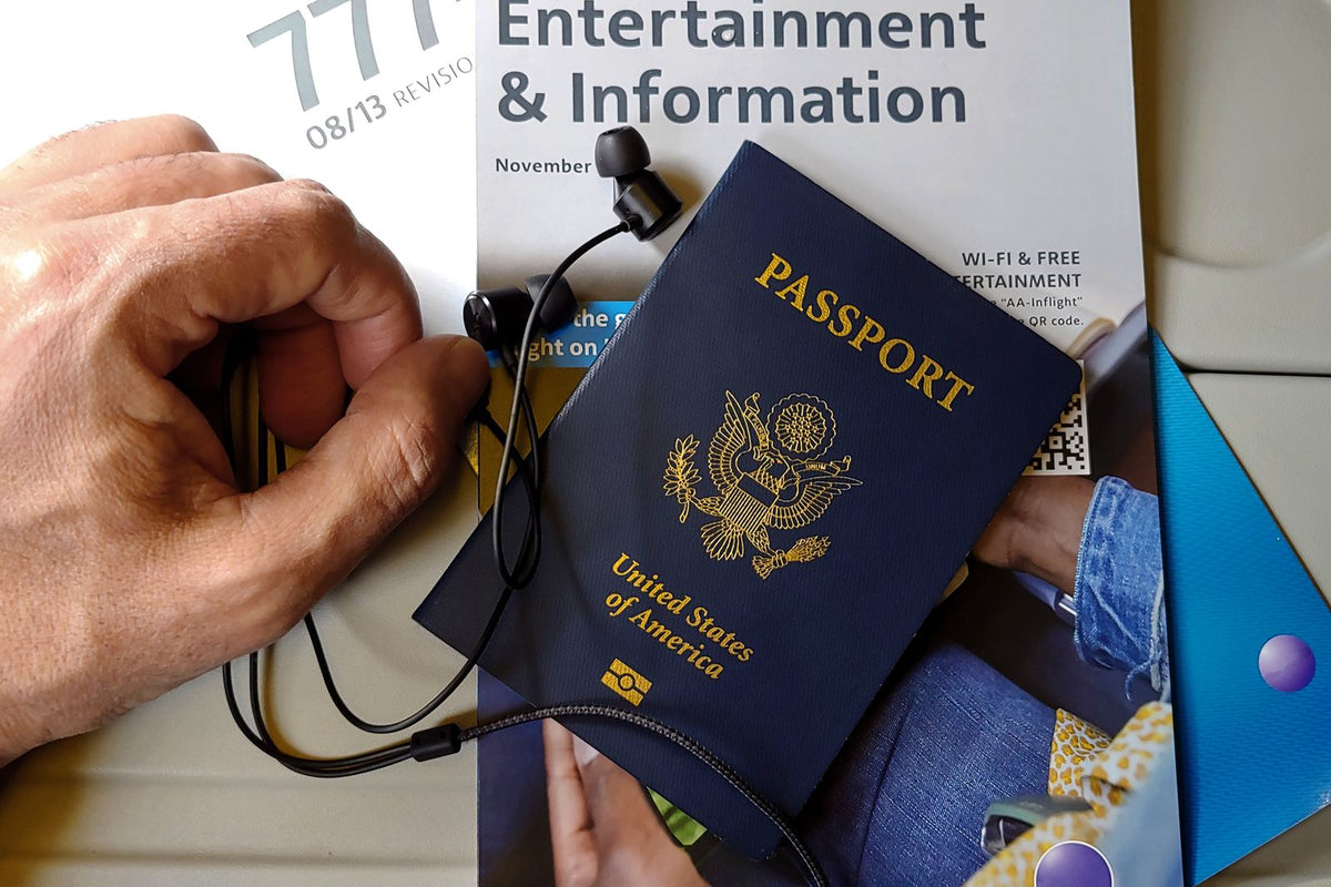 US passport resting on an airline in-flight magazine during a flight to Hawaiʻi