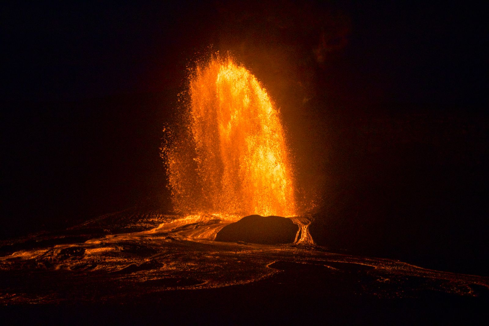 Lava erupting at night from Hawaii Volcanoes National Park on the Big Island of Hawaii
