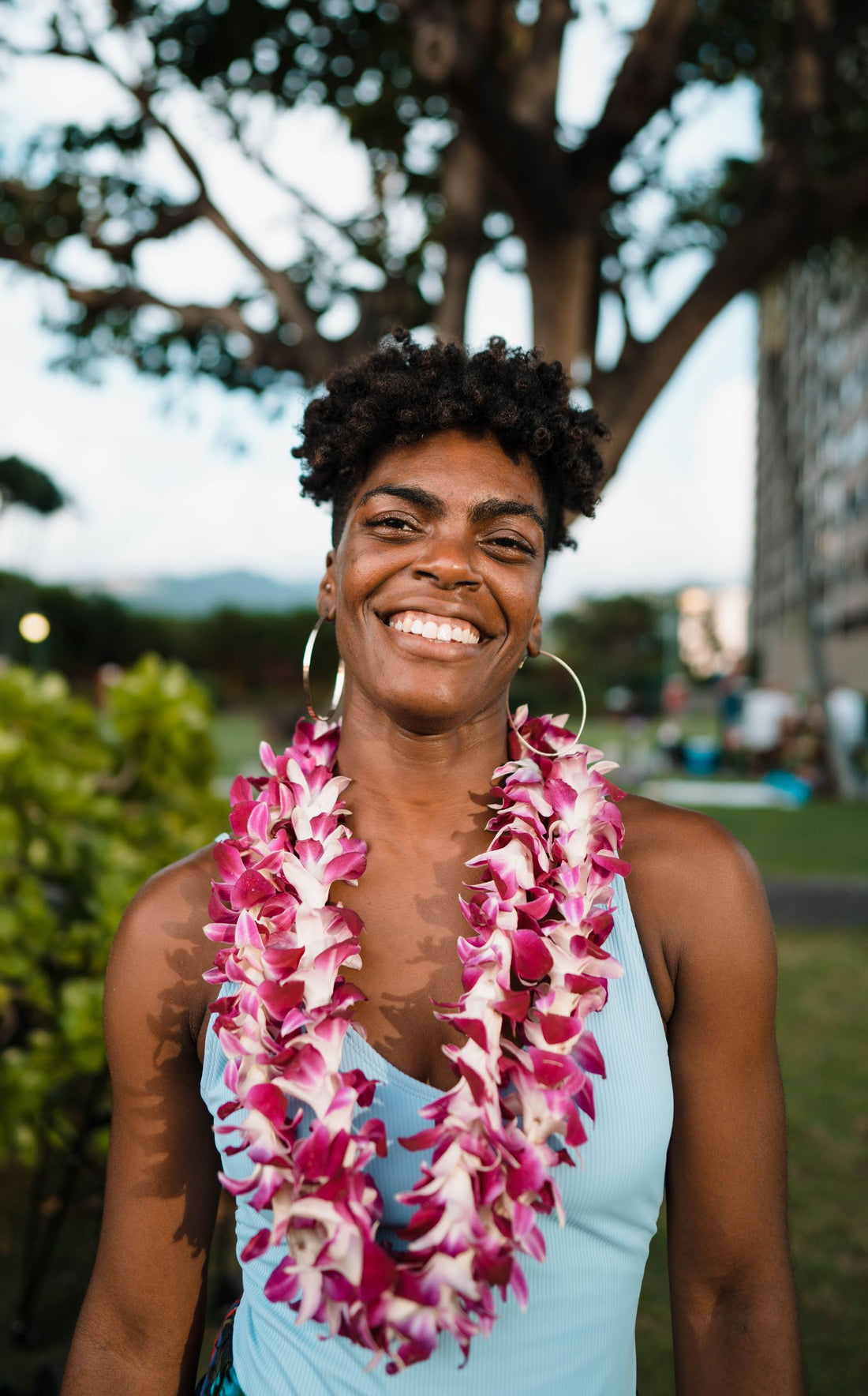 A person wearing a Hawaiian flower lei, a gesture of aloha and mahalo