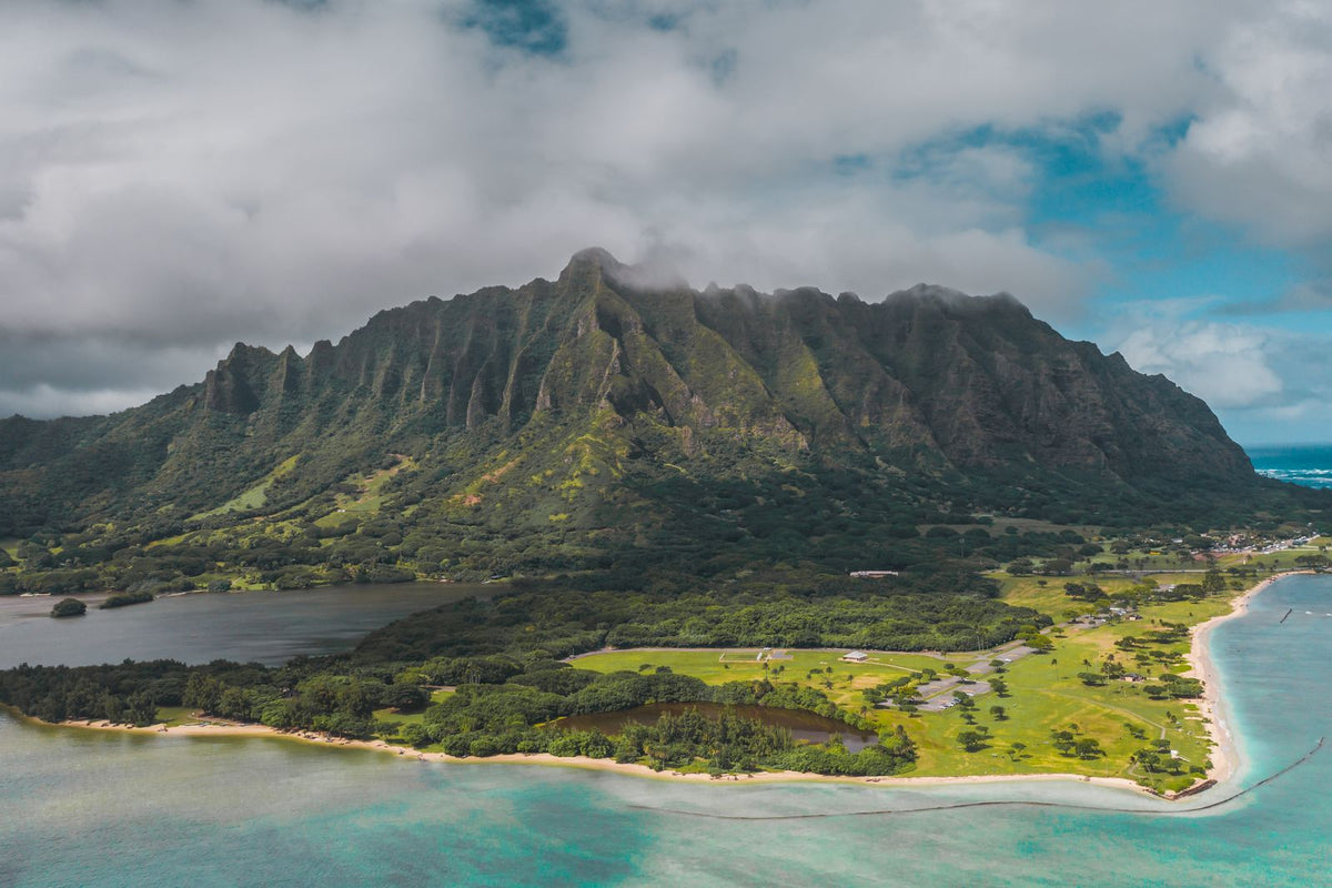 Aerial view of a lush Hawaiian island coastline with mountains and turquoise water, Hawaiʻi