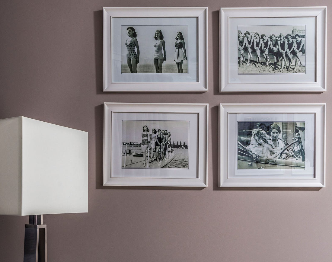 A gallery wall of four framed art prints arranged in a grid on a wall, illustrating how to decorate with Hawaiian wall art