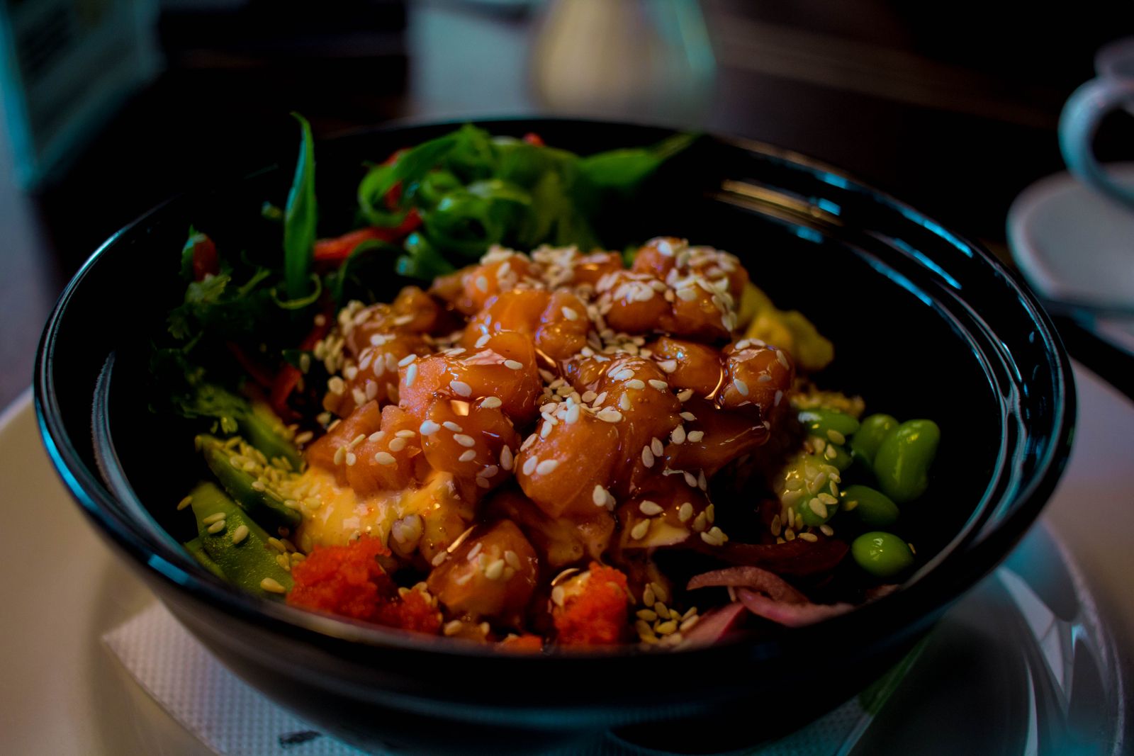 Fresh poke bowl with salmon, avocado, edamame, and sesame seeds, Hawaiʻi style