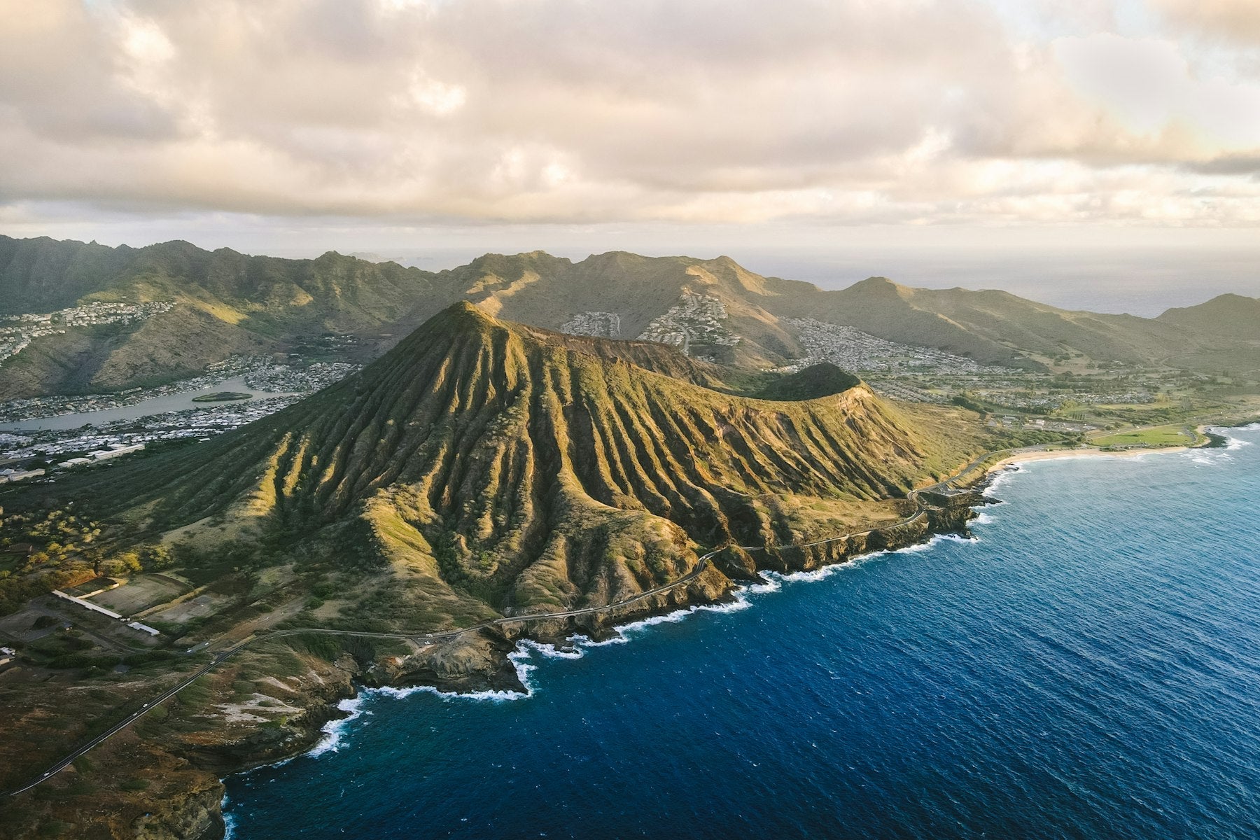 Aerial view of a Hawaiian mountain ridge running down to the ocean on Oʻahu, showing the mauka-to-makai shape of an ahupuaʻa