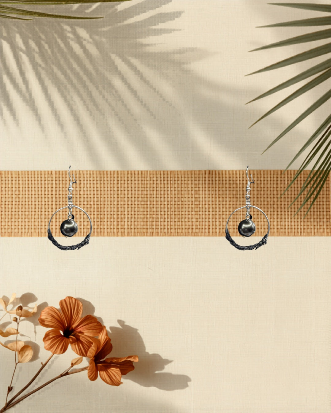 Lauhala half wrap silver hoop earrings styled on tropical Hawaiian background